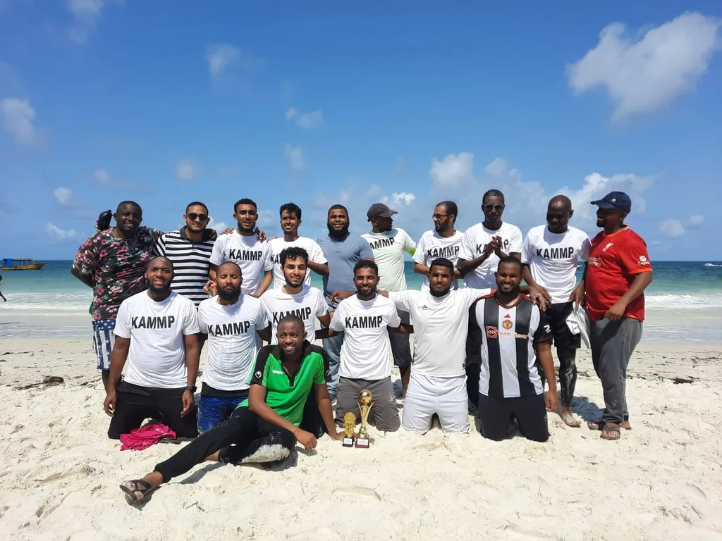 A group of members photographed on a beach