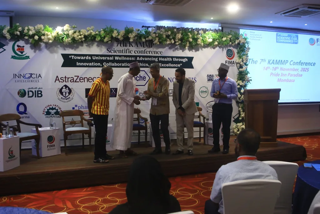 Officials of the association on the stage presenting a recognition at the 7th KAMMP Scientific Conference, 2025