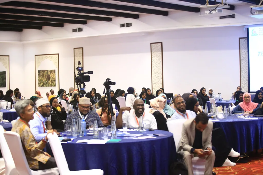 Delegates filling the round tables of the conference hall during a plenary session of the 7th KAMMP Scientific Conference, 2025