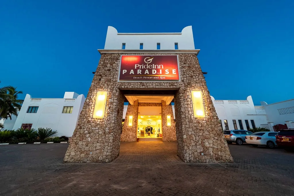 The entrance of the conference hotel lit up at dusk