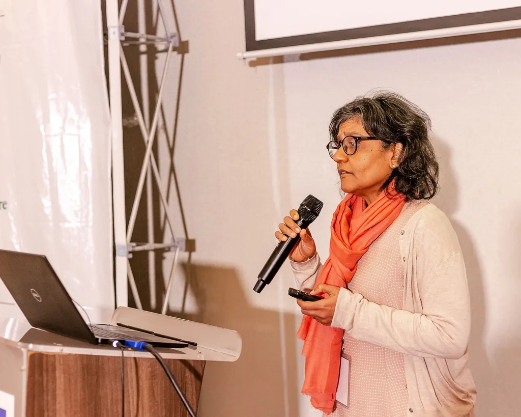 A speaker presents with a microphone at the 4th KAMMP conference, Nairobi 2022
