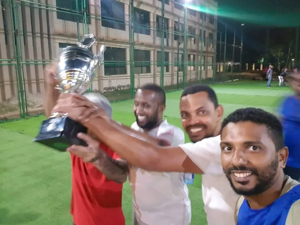 KAMMP footballers lifting a trophy after an evening match