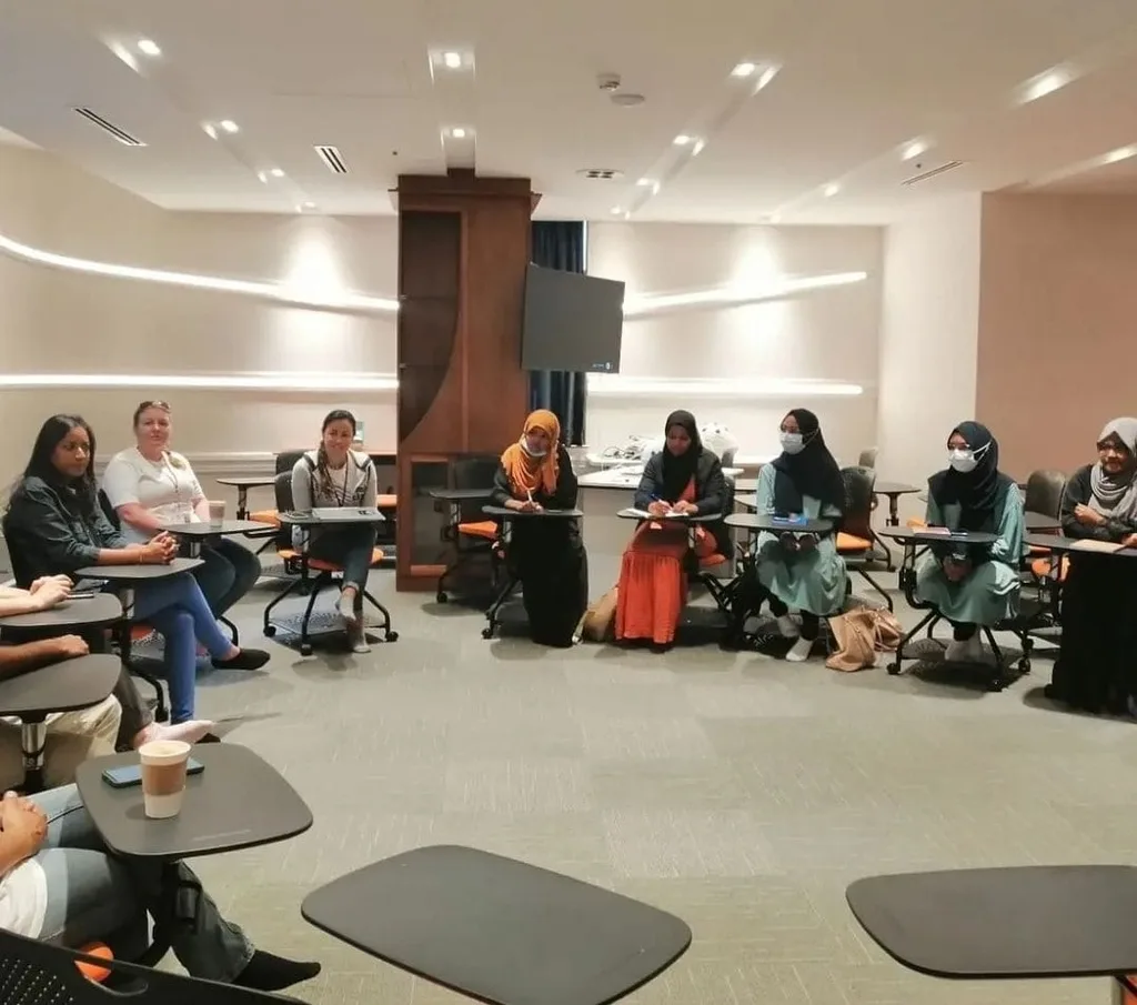 Participants seated around a meeting room during a session