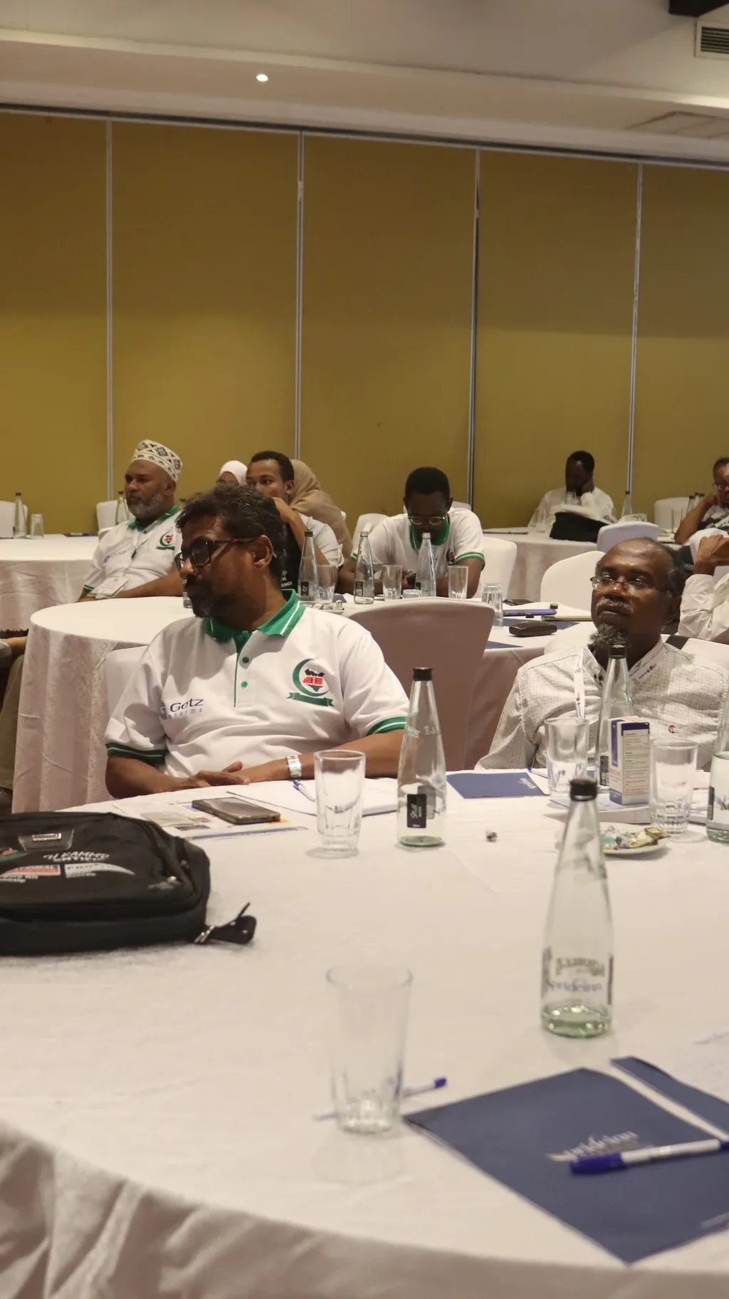 Delegates at a table during the 5th KAMMP Scientific Conference, 2023