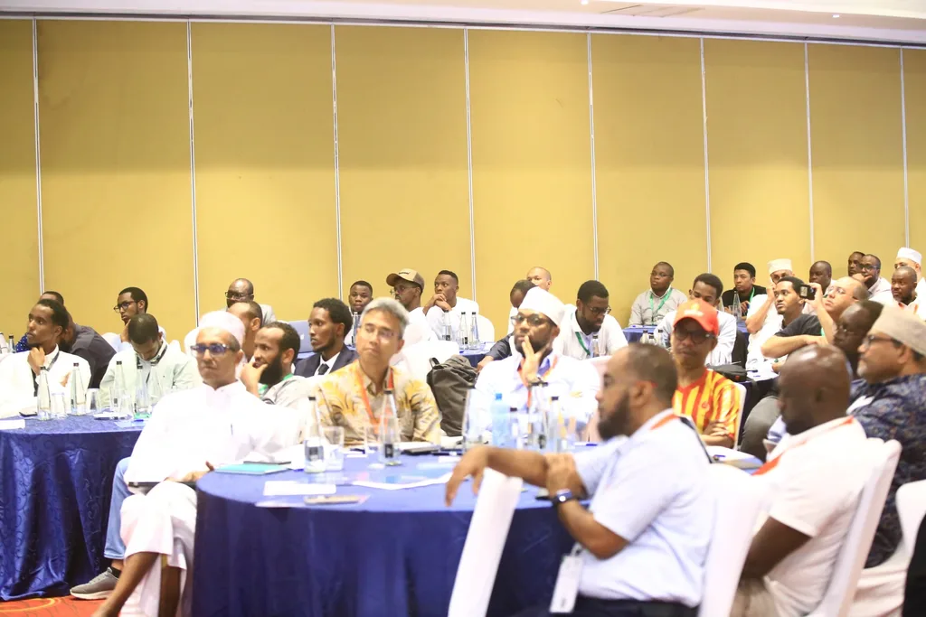 Delegates listening closely at their tables during a session of the 7th KAMMP Scientific Conference, 2025