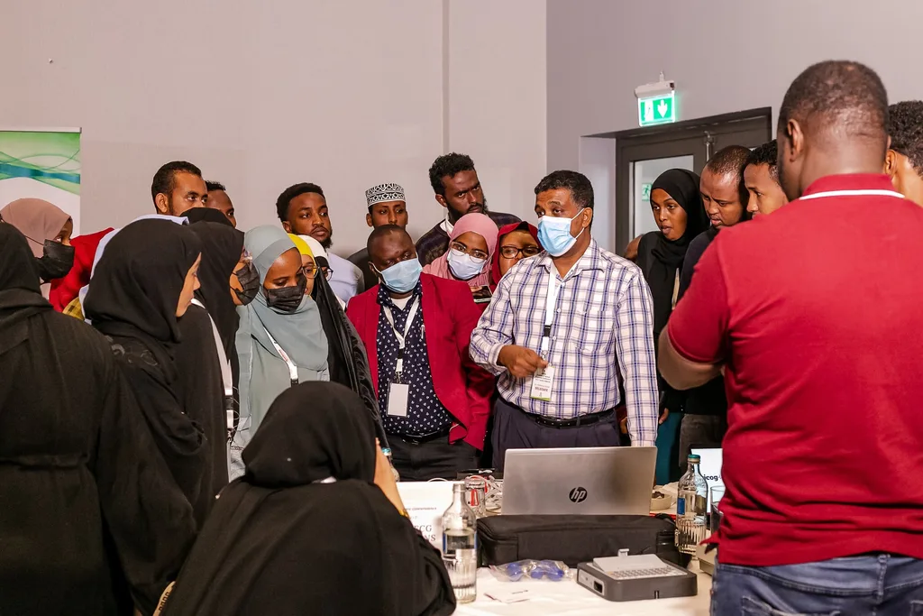 Delegates gather round a skills demonstration at the 4th KAMMP conference, Nairobi 2022